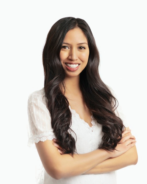 Bowie Medical Studio team member Catherine Carrillo, a registered nurse, posing and smiling in a white shirt